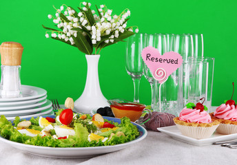 Table setting on green background