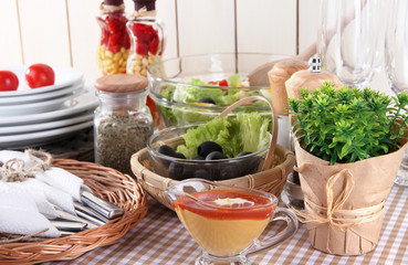 Table setting on checkered tablecloth on wooden background