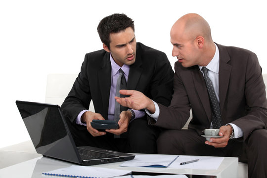 Two businessmen preparing proposal
