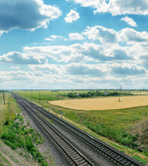Fototapeta na wymiar railroads to horizon and cloudy sky