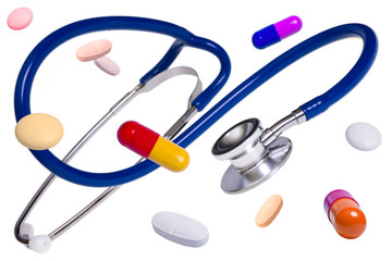 Blue medical stethoscope with pills and tablets