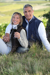 couple drinking wine in their vineyard