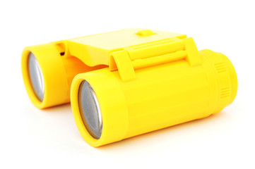 kids yellow plastic binoculars on white background