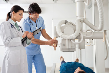 Radiologists Performing X-ray On Patient