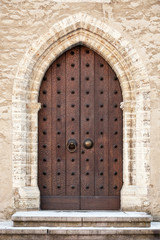 Fototapeta na wymiar Ancient dark wooden door. Tallinn, Estonia