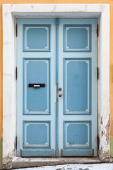Blue wooden door in old building facade. Tallinn, Estonia