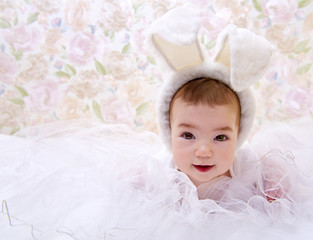 Happy baby in white rabbit costume