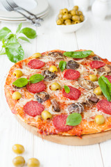 pizza with salami and sliced ​​mushrooms