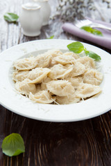 round meat ravioli with basil and parmesan