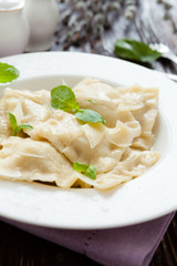 square meat ravioli with basil and parmesan