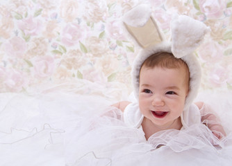 Smiling baby in rabbit costume