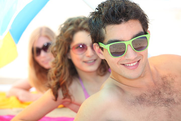 Youth on the beach wearing sunglasses