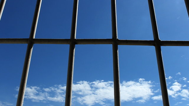 Prison bars and blue sky, dolly