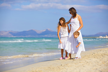Fototapeta na wymiar Mother with kids on beach