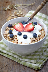 Bowl of healthy muesli with yogurt and fresh berries