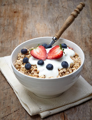 Bowl of healthy muesli with yogurt and fresh berries