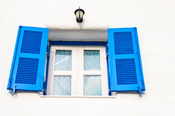 Close up Blue window on white wall background.