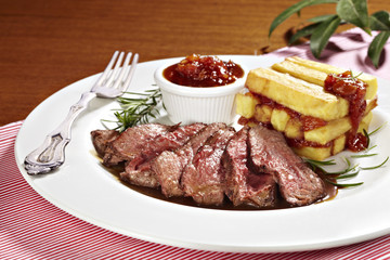 sirloin steak with fried potatoes and tomato sauce