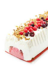 Ice cream cake with berries and nuts on white
