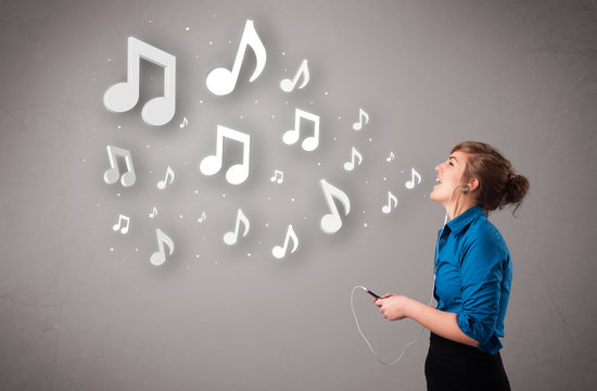 Pretty young woman singing and listening to music with musical n