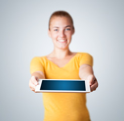 Young woman holding modern tablet