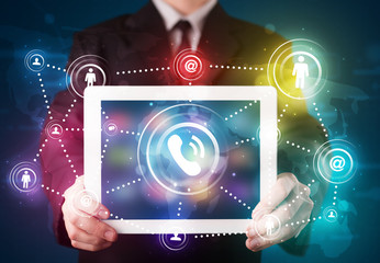 Businessman showing social networking technology with colorful l