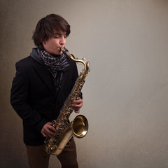 Fototapeta premium Young musician playing on saxophone