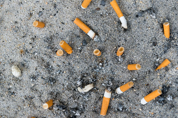many ready smoked cigarettes butt stick in sand