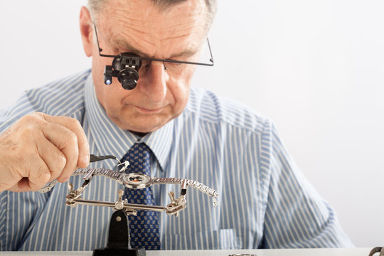 Older Man Repairing Watchmaker