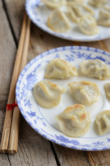 Fototapeta na wymiar Fried meat dumplings on white and blue plates