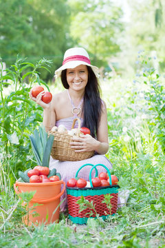 Happy  woman with harvested vegetables