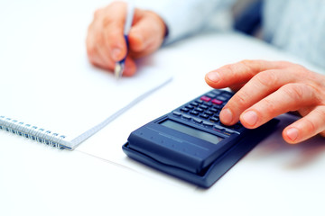 Closeup of a businessman calculating