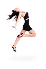 Cute elegant woman in black dress jumping