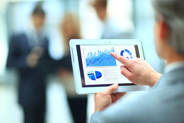 Handsome businessman using his digital tablet