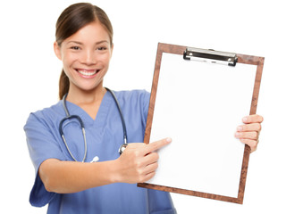 Nurse showing medical sign clipboard copy space
