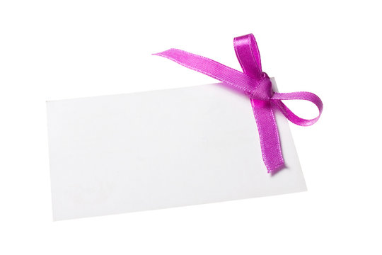 Blank gift tag tied with a bow of red satin ribbon. 