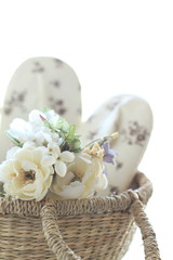 handmade slipper and artificial flower in basket for interior