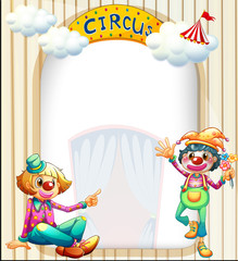 A circus entrance with a male and a female clown