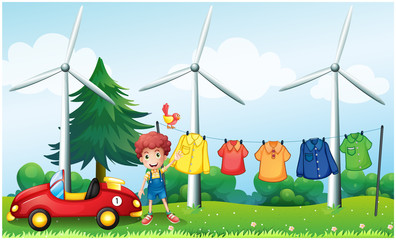 A boy in the garden with his car and hanging clothes