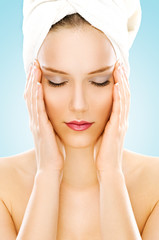 Beauty with towel isolated on blue