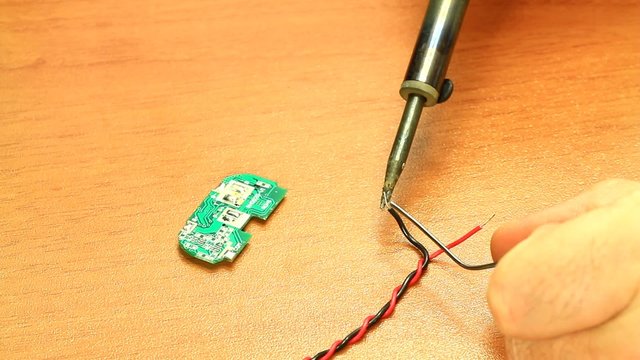 Soldering the wires using a soldering iron