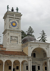 Fototapeta premium ancient Bell Tower with two African statues over flying hours in