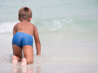 Back view of boy in the sea. © maikuto