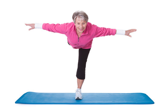Senior Woman Standing On One Leg And Exercising