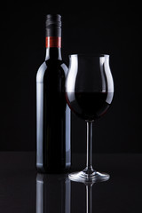Bottle Of Wine And Glass Isolated On Black Background