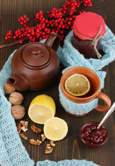 Helpful tea with jam for immunity on wooden table close-up