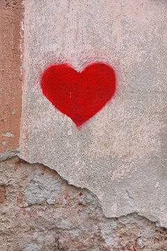 bright red heart drawn by a lover on a wall