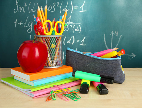 Back to school - blackboard with pencil-box and school