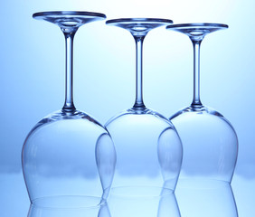 Empty wine glasses arranged on blue background