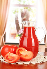 Tomato juice in pitcher on table on in room